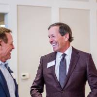 Dan DeVos talking with a guest.